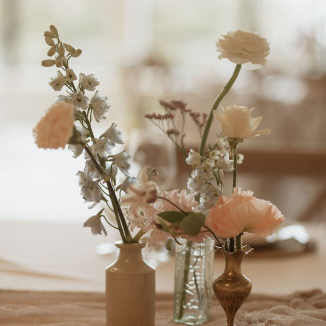 Floral bud vases, with pale pink and blue flowers