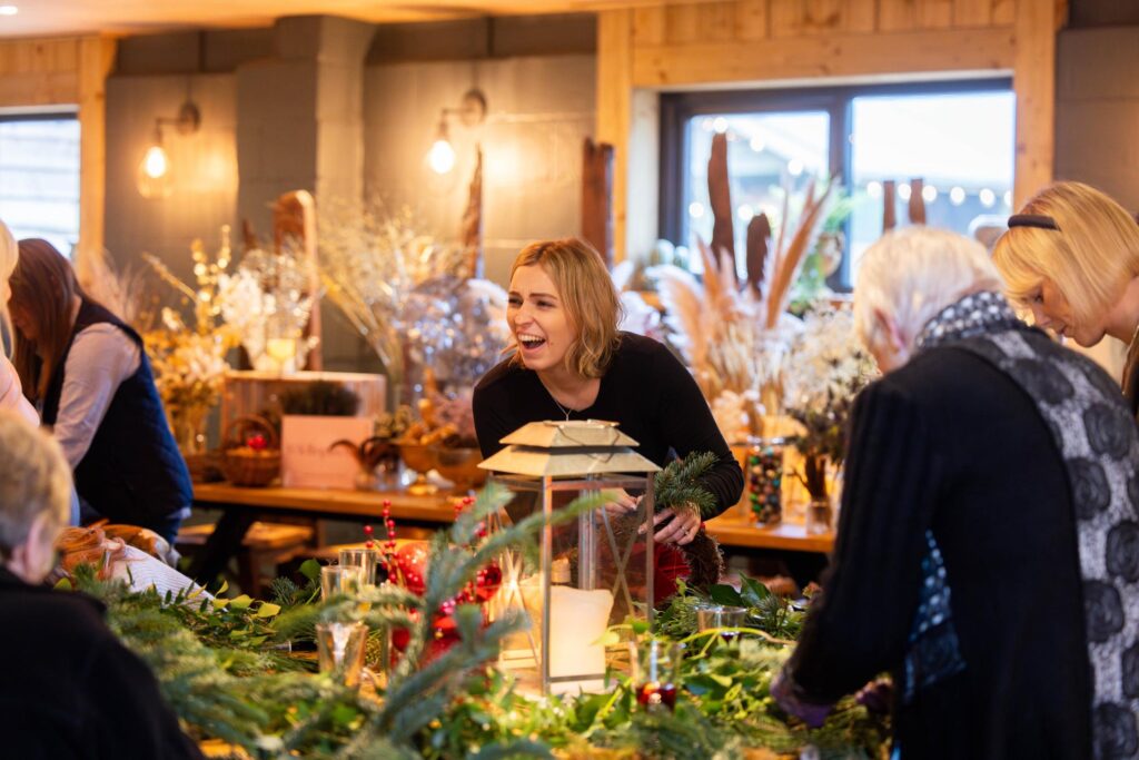 Guests learning how to make their own Christmas Door wreaths.